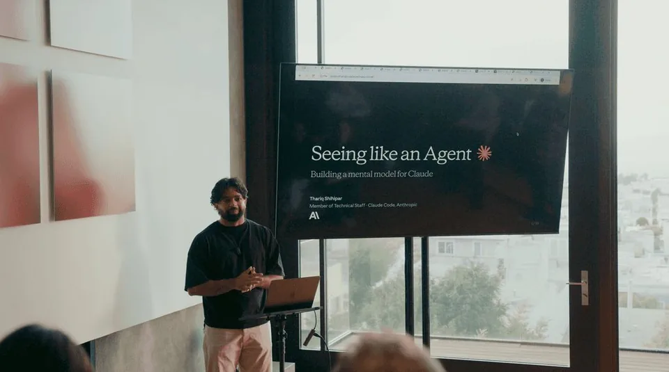 Thariq presenting “Seeing like an Agent” beside a big window